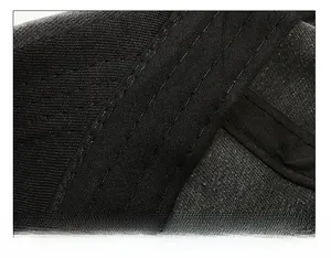 Detail view of reinforced sweatband stitching on a washed green baseball cap