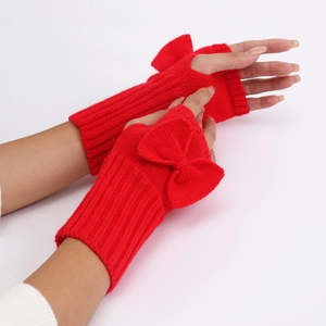 Close-up of red knit fingerless gloves featuring a cute bow detail and ribbed cuffs