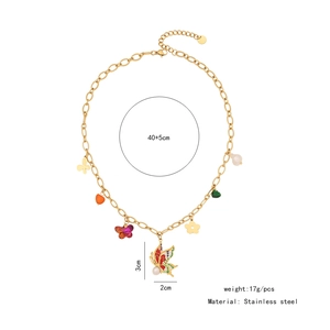 Detailed macro view of stainless steel chain with butterfly pendants and white pearl charms