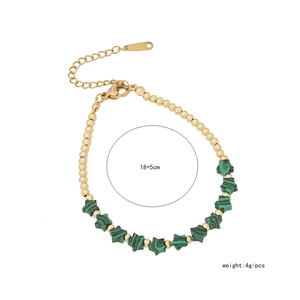 Detailed shot of handmade 18K gold plated star bracelet with green natural stone