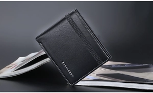 Close-up of black leather bifold wallet featuring Greek key pattern and embossed logo detail