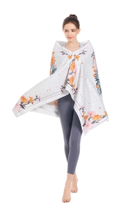 Detail of soft microfiber beach towel showing orange floral print on a white base