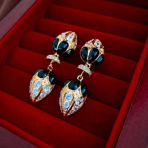 French vintage zircon water drop earrings in gold plating displayed on red velvet