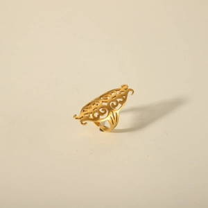 Vintage hollow patterned 18K gold plated stainless steel open ring on beige background