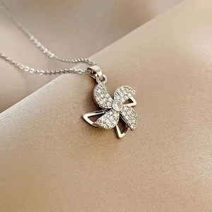 Rotating windmill pendant necklace for women with sparkling cubic zirconia on silver chain