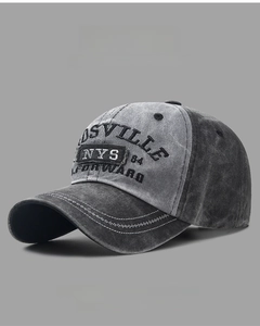 Detail of vintage washed baseball cap featuring contrast stitching and 3D embroidery
