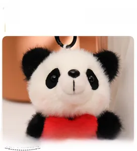 Close-up of cute panda plush pendant featuring soft texture and red heart embroidery