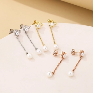 Detailed view of butterfly tassel pearl earrings in silver, gold and rose gold finishes