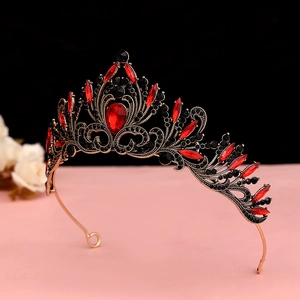 Detailed view of Baroque vintage black crown with red ruby-style gemstones and fine crystals