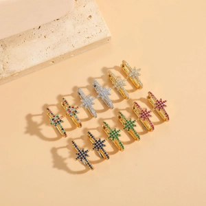 Detailed flat lay of starburst hoop earrings featuring multi-color zircon stones
