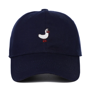 Detailed view of navy blue cotton baseball cap featuring white cartoon duck embroidery