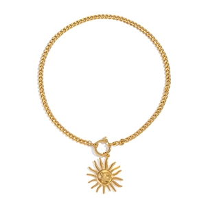 Close-up of golden chunky Cuban chain with sun face pendant and T-bar clasp design
