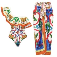 Detail of two-piece swimwear with Sicily tile print featuring one-shoulder suit and sarong