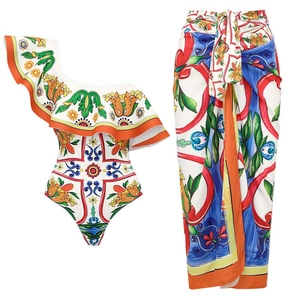 Women's one-shoulder ruffle swimsuit and matching sarong set with tile print