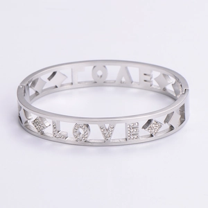 Detail of silver LOVE lettering and diamond-set geometric clasp on stainless steel bracelet