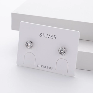 Detailed view of S925 sterling silver round zircon stud earrings on white display card