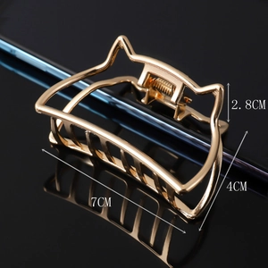 Detailed view of large golden cat-ear metal hair claw clip with size measurements