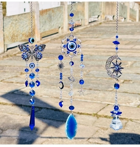 Detail of blue evil eye butterfly suncatcher with crystal pendants and metal ornaments