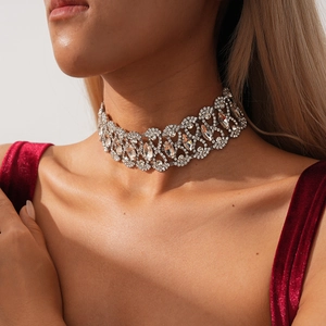 Detailed view of silver wide hollow choker necklace with rhinestone patterns on neck