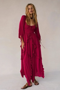 Detail of bohemian deep pink bohemian long dress showing ruffled texture and lace patchwork design