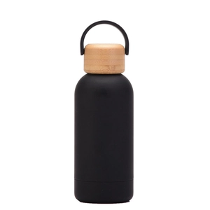 Detail of matte black insulated flask featuring a natural bamboo lid and portable handle