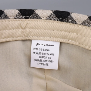 Close-up of linen baseball cap inner lining with washing label showing fabric composition