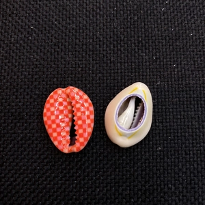 Detail of colorful checkerboard pattern and floral prints on natural sea shell beads