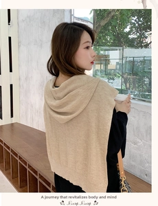 Detailed knit texture and hood silhouette of beige winter shawl scarf on a model