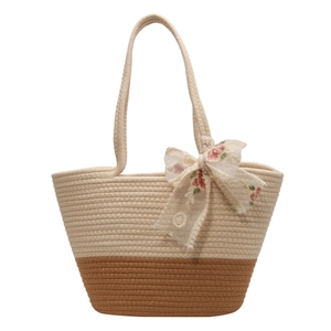 Large woven beach tote bag in beige and brown with floral lace bow and sturdy handles