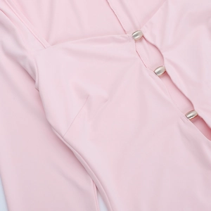 Close-up of pink dress fabric showing three gold metal horizontal bar buttons in detail