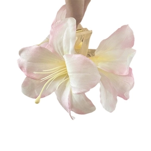 Elegant 3D lily hair claw clip with pink and yellow gradient fabric petals and yellow stamen