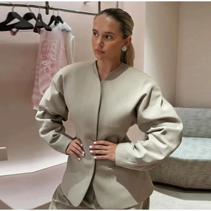 Structured beige woven blazer for women featuring a minimalist collarless oversized design