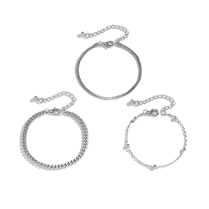 Close-up of three silver snake, curb, and satellite chains with lobster clasp details