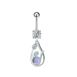 Macro shot of silver navel ring with zircon and tulip pendant with blue moonstone
