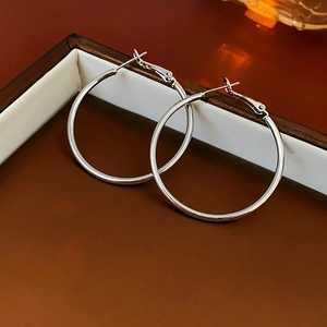 Detailed macro view of 925 sterling silver hoop earrings in an elegant jewelry box