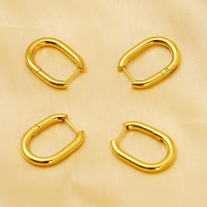 Minimalist 18k gold-plated oval hoop earrings on elegant gold satin background