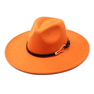 Detail of orange wide brim felt fedora hat featuring a black belt and gold metal buckle