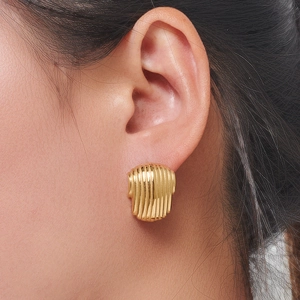 Minimalist gold striped stainless steel earrings shown on model for elegant daily wear