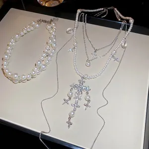 Elegant multi-layered pearl necklace set with crystal cross pendants for women