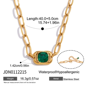 Detail of gold chain necklace with emerald green square stone and product size specs