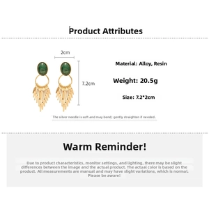 Detailed view of resin oval earrings with gold tassel, weighing 20.5g and measuring 7.2x2cm