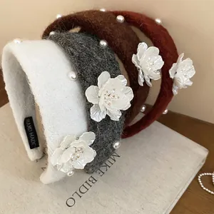 Handmade knitted floral headband with pearls in autumn colors for women's hair styling