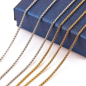 18K gold and silver plated titanium steel box chain necklaces on a blue jewelry box