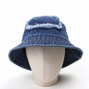 Close-up of distressed denim bucket hat with frayed edges and vintage washed finish