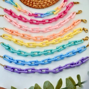 Macro shot of colorful matte acrylic links with adjustable gold-tone lobster clasps
