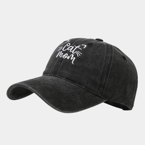 Detail of white Cat Mom embroidery and cat whiskers on washed black denim baseball cap