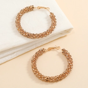 Macro view of gold round hoop earrings with high-density sparkling rhinestones