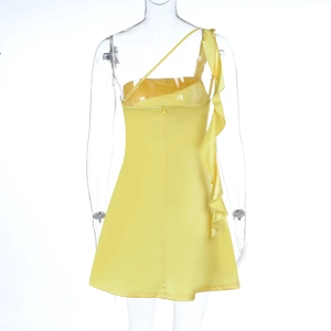 Detail view of the back of a yellow satin mini dress with ruffles and a slim fit