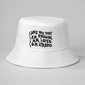 White cotton bucket hat featuring black embroidered Body Positivity quotes for sun protection