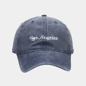 Detail of Los Angeles embroidery on washed navy blue cotton baseball cap